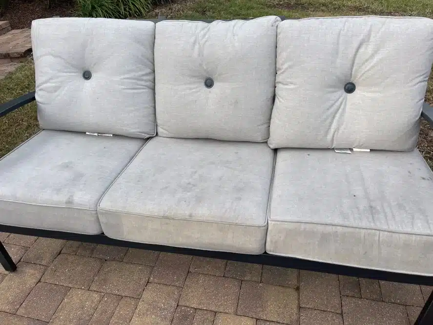 Before picture of grimy moldy patio cushion until we revive with POFL Cleaner