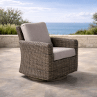 Outdoor wicker armchair with weather resistant upholstered cushion