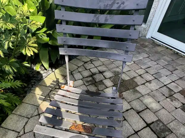 before metal restoration done on outdoor chair by Premium Outdoors FL here in Ponte Vedra Beach Florida
